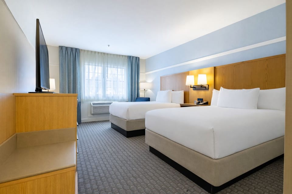 Double/Double Deluxe Room | In-room safe, desk, laptop workspace, blackout drapes