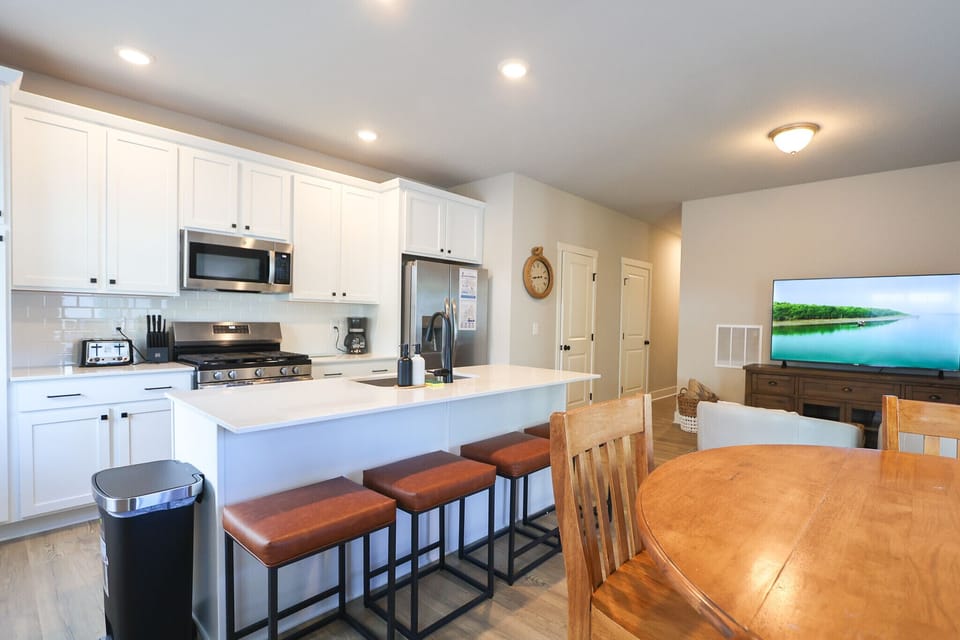 Open concept kitchen, Enjoy stainless-steel appliances, a spacious island with seating for four and fully stocked essentials for cooking and coffee.