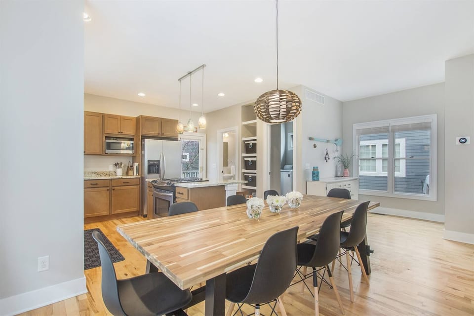 Bright and open kitchen and dining area with modern appliances and a large table.