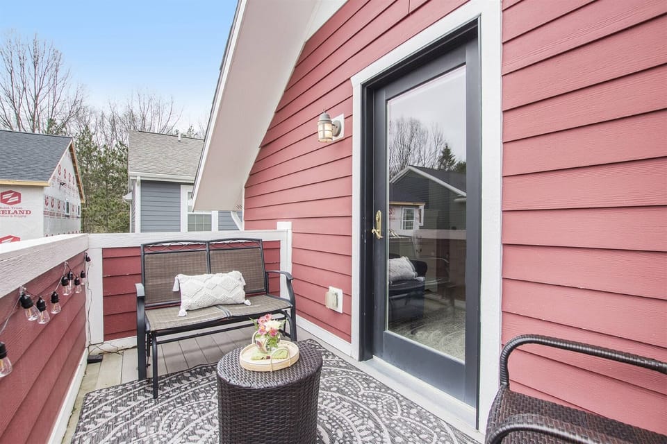 Enjoy your own private balcony off the primary bedroom, complete with cozy seating.