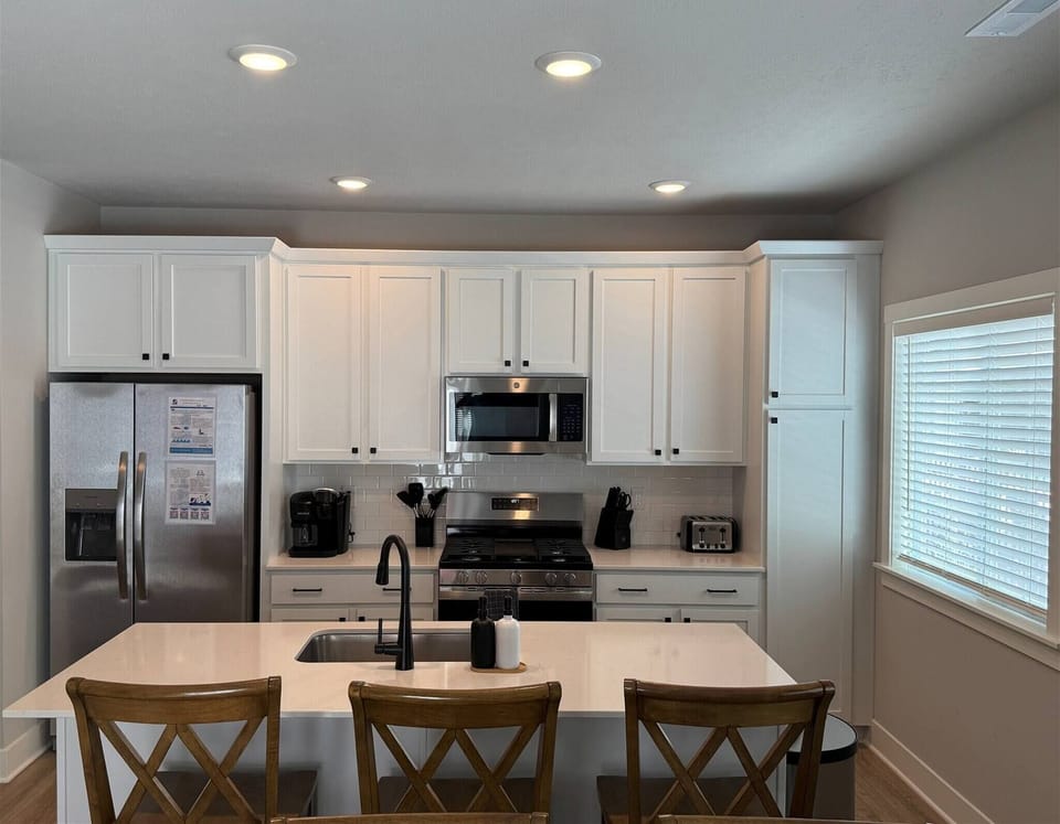 Bright, Modern kitchen with stainless steel appliances and a large island