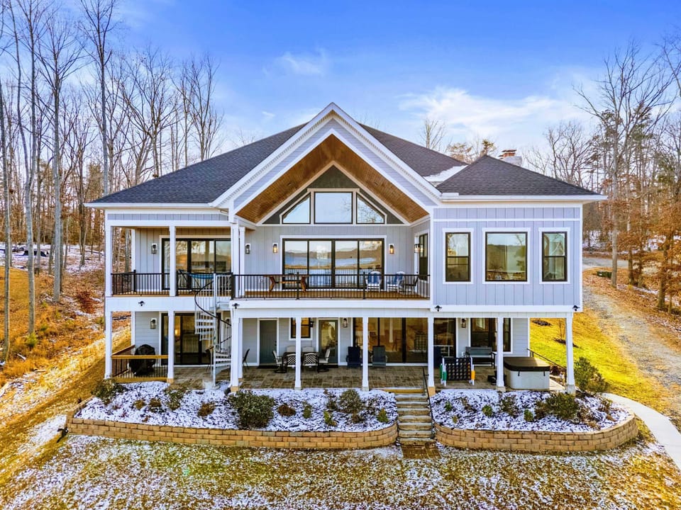 Drone View - From above, the custom-built estate, covered patio, and manicured walkway lead straight to the massive dock.