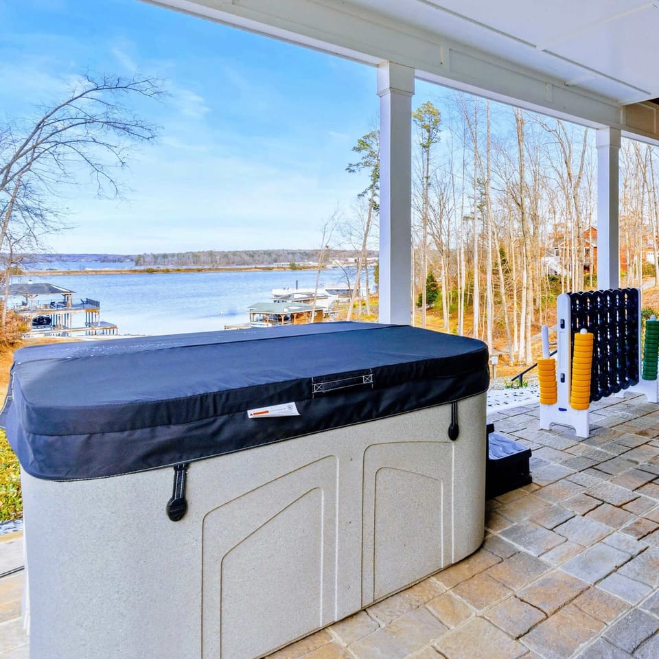 Exterior - The full lakefront property and covered dock, with neighboring homes dotting the shoreline.