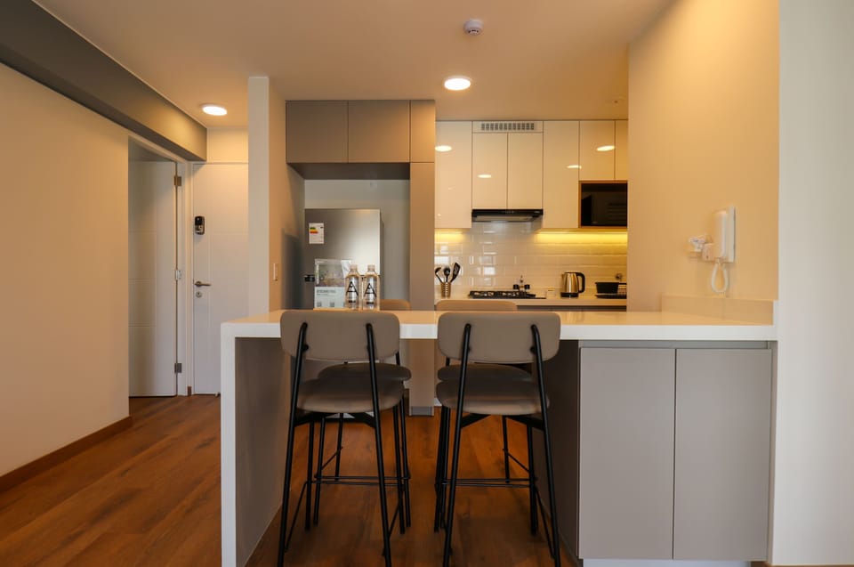 Modern kitchen with breakfast bar and stylish seating.