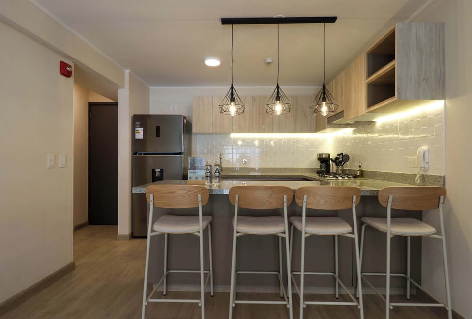 Open-concept kitchen and dining area with a clean, modern layout and warm lighting.