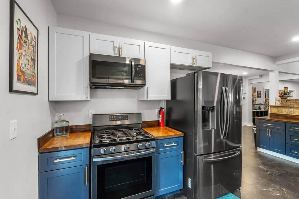 This charming kitchen is designed for both comfort and functionality. Featuring a sink, ample cabinet space, a refrigerator, and a stove, it has everything you need for cooking meals.