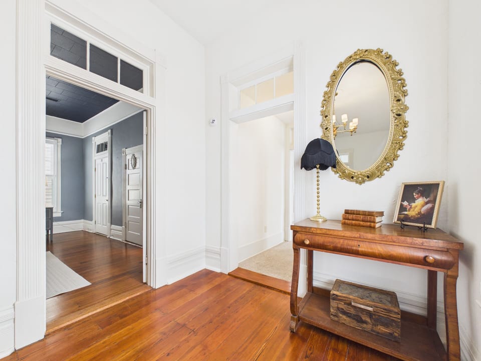 Step through sunlit hallways where warm wood floors, vintage details, and timeless decor set the tone. Each doorway invites a new discovery, creating a stay that feels both storied and effortlessly welcoming.