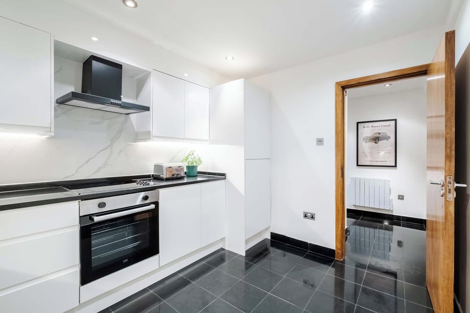 Full Kitchen | Fully equipped kitchen with everything you need for a short or long stay, including a fresh water dispenser, coffee machine, washing machine and dryer, and a dishwasher.