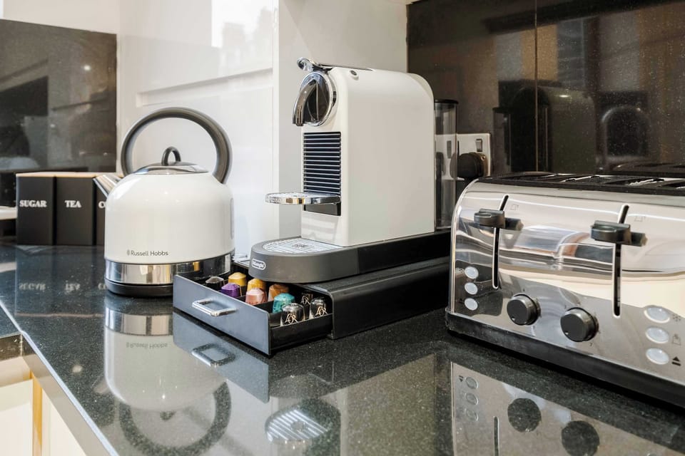 Full Kitchen | Savor the luxury of a fully-equipped kitchen, designed for any duration of stay. Revel in modern conveniences such as a washer, dryer, dishwasher, Nespresso machine, and a fresh water dispenser, ensuring your comfort and convenience.