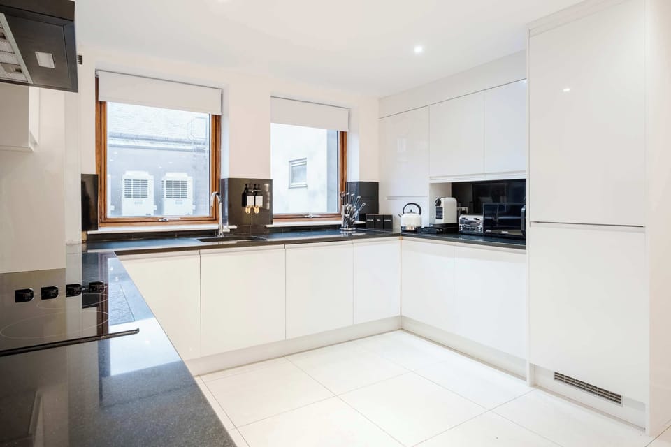 Full Kitchen | Savor the luxury of a fully-equipped kitchen, designed for any duration of stay. Revel in modern conveniences such as a washer, dryer, dishwasher, Nespresso machine, and a fresh water dispenser, ensuring your comfort and convenience.