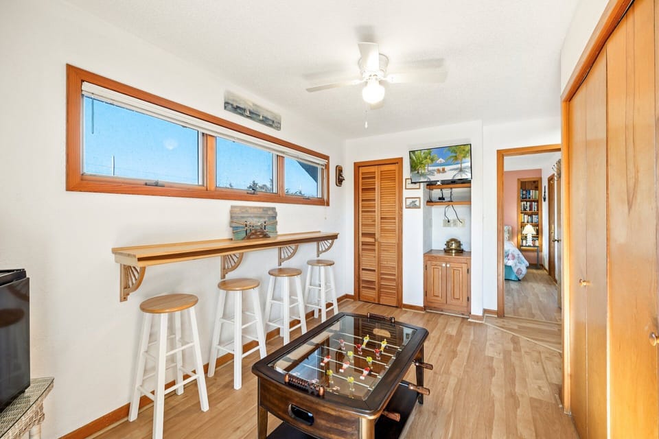 This space features a foosball table and an electronic dartboard.