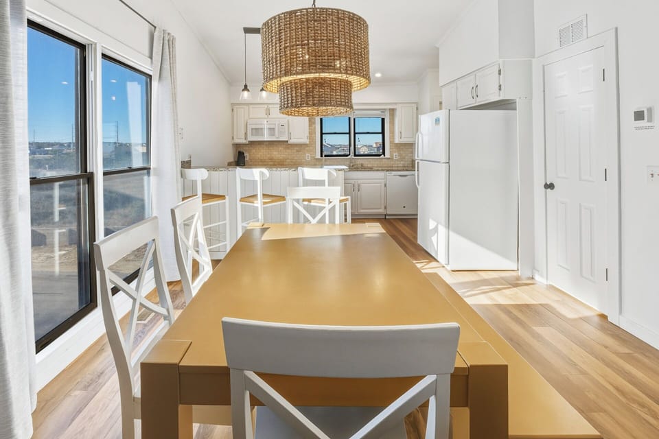 The dining area flows seamlessly from the kitchen and living space, making meals together easy and relaxed.