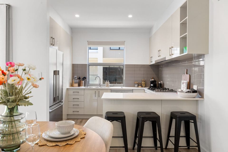 Gather around the central island, where cooking, conversation, and casual meals naturally come together.