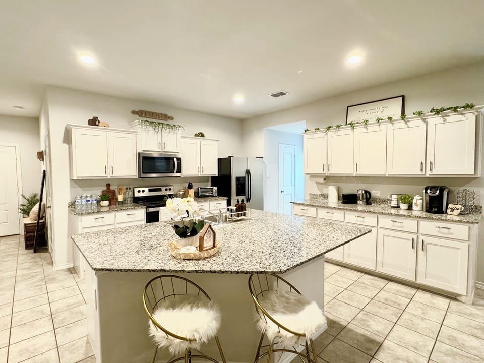 Fully stocked kitchen with all essential supplies, cookware, and utensils.