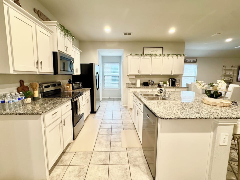 Fully stocked kitchen with all essential supplies, cookware, and utensils.