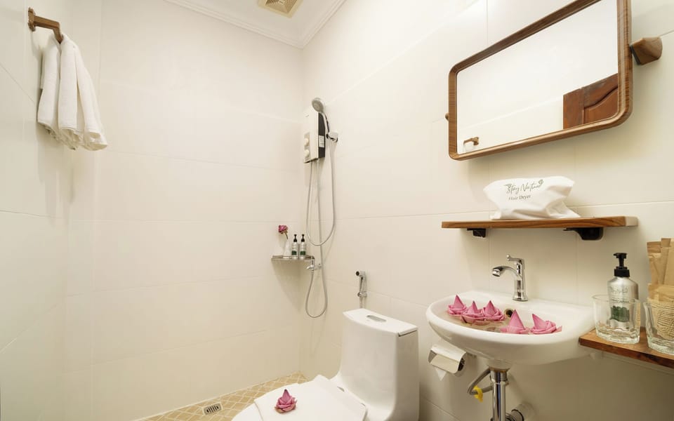 Suite, Pool View | Bathroom | Shower, hair dryer, slippers, towels