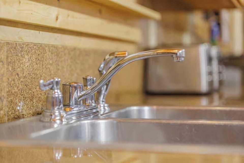 Double sink with modern fixtures blending rustic charm and everyday convenience.