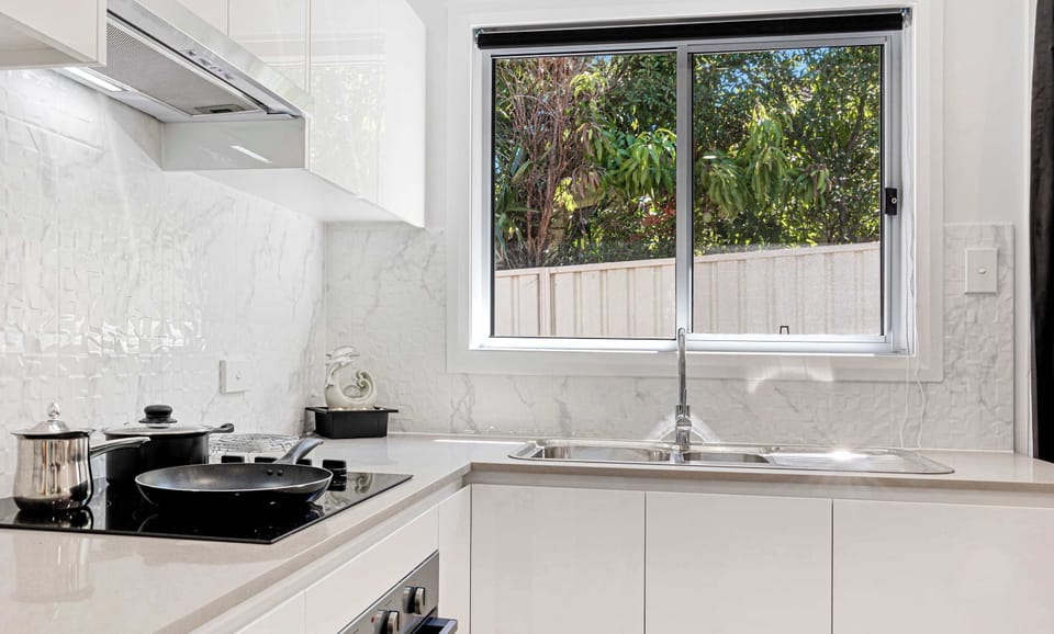 Functional cooking space with modern appliances and plenty of storage.