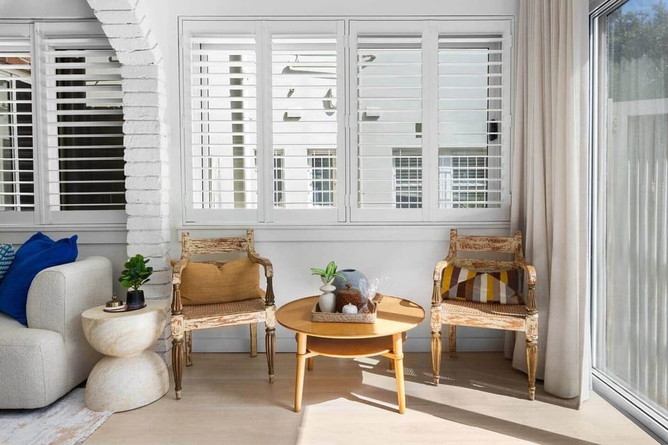 
Enclosed balcony sunroom with seating in Bondi apartment