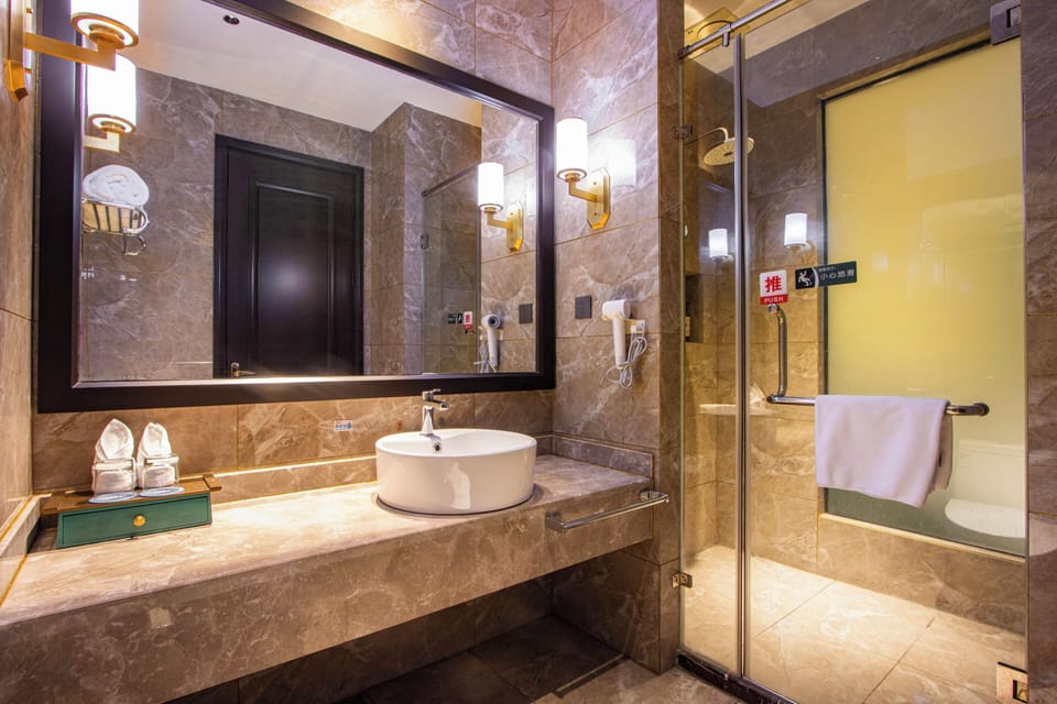 Shower, hair dryer, slippers, towels