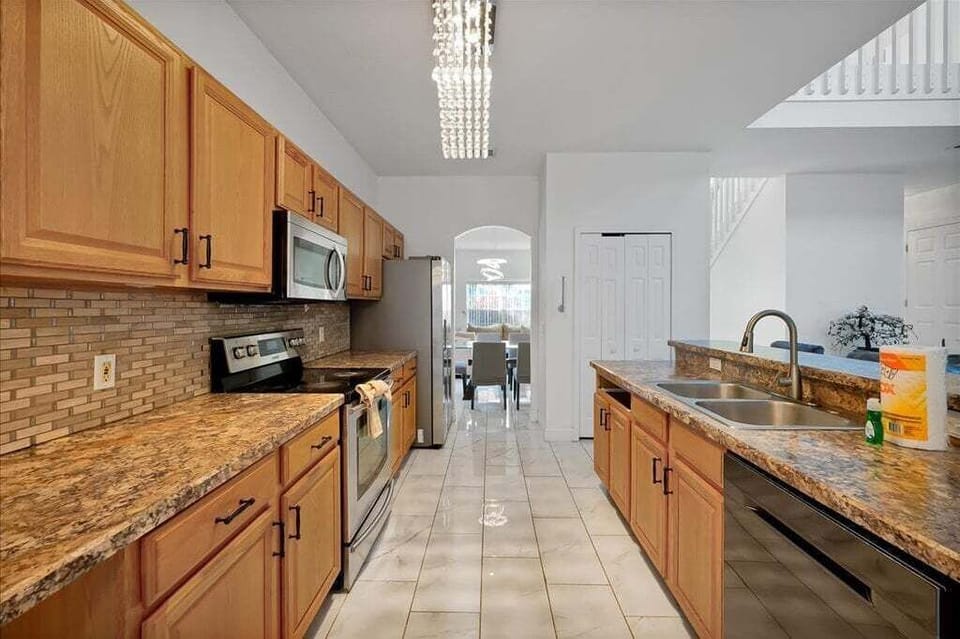Equipped kitchen with ample counter space for cooking.