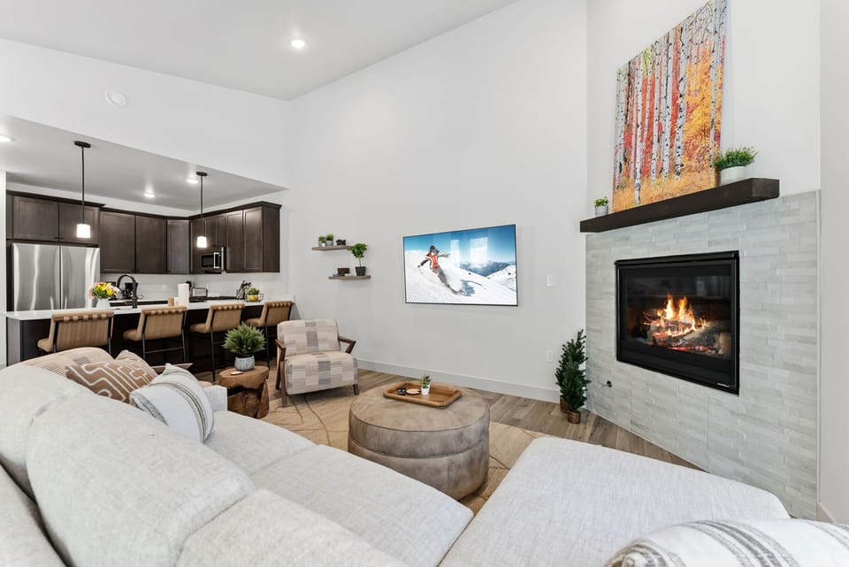 Sink into plush seating by your crackling fireplace, where modern comfort meets cozy warmth in this beautifully appointed living space.