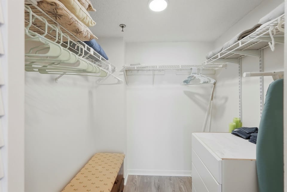 The common bathroom offers a clean, functional layout with a walk-in shower, toilet, and vanity. It also includes plenty of closet and storage space, providing added convenience for guests during their stay.