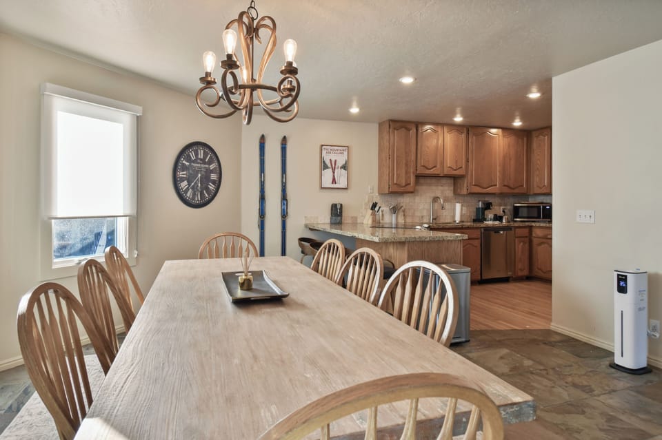 Your spacious dining room flows seamlessly into a fully equipped kitchen, perfect for family meals and mountain vacation memories.