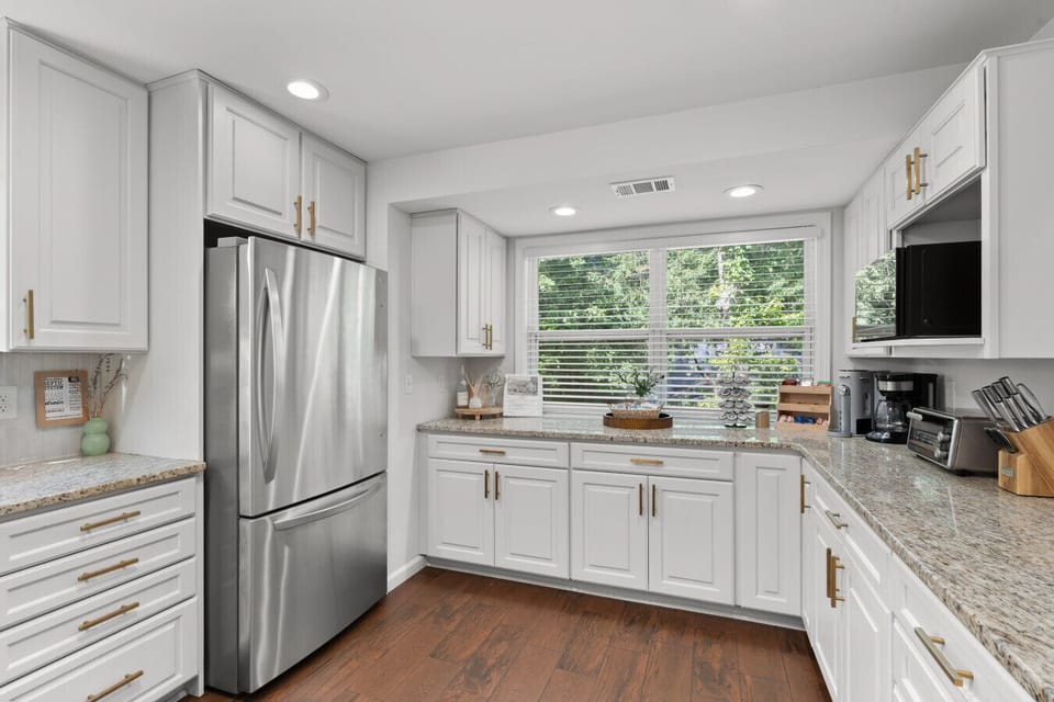 Fully equipped kitchen with granite countertops, gas range, and plenty of prep space for family breakfasts, team meals, and extended stays.