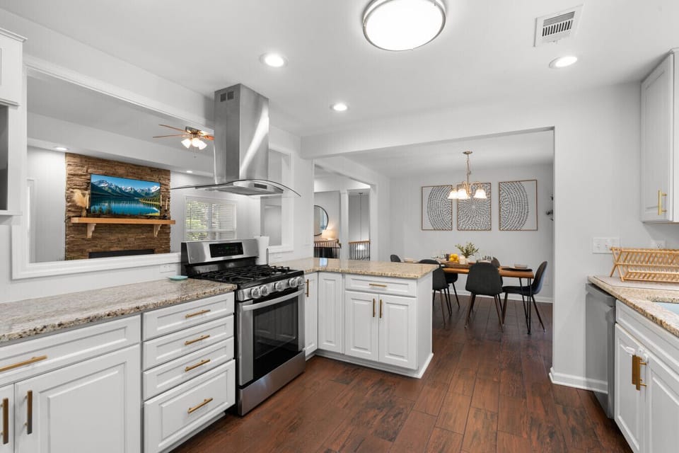 Fully equipped kitchen with granite countertops, gas range, and plenty of prep space for family breakfasts, team meals, and extended stays.
