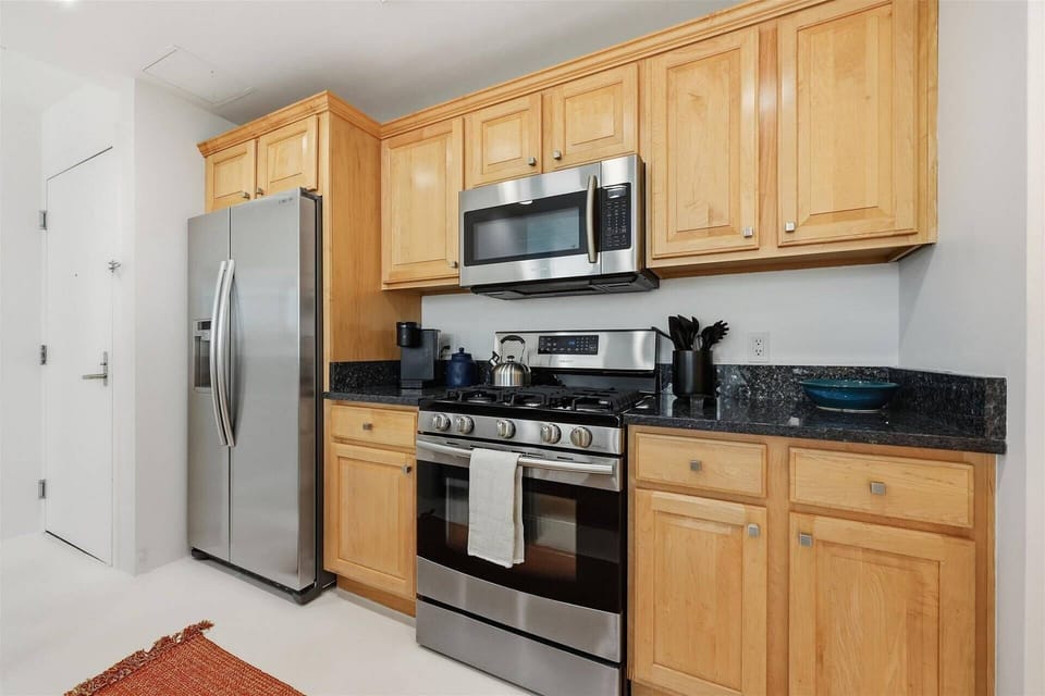 Norwegian Blue Pearl slab granite countertops throughout the kitchen and bathroom