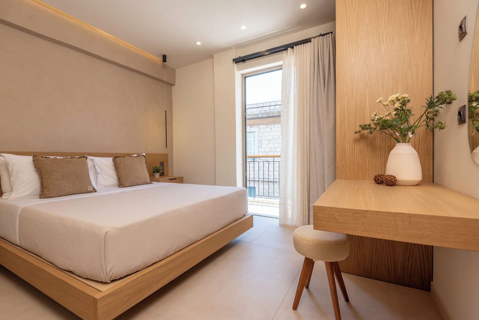 Serene and sunlit bedroom with an island-style bed.