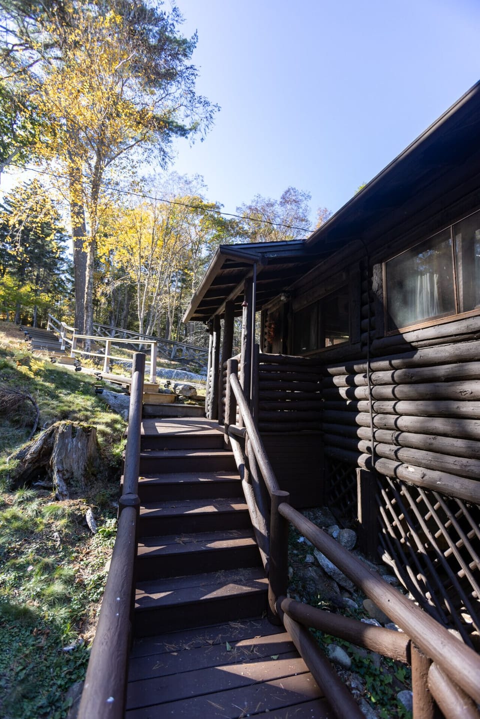Original cabin staircase with narrow steps and natural wood finish. Beautifully preserved, though not recommended for mobility-impaired guests.