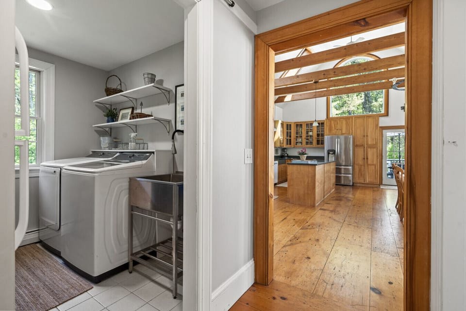 Washer and dryer located off of mudroom and kitchen areas as you enter the home