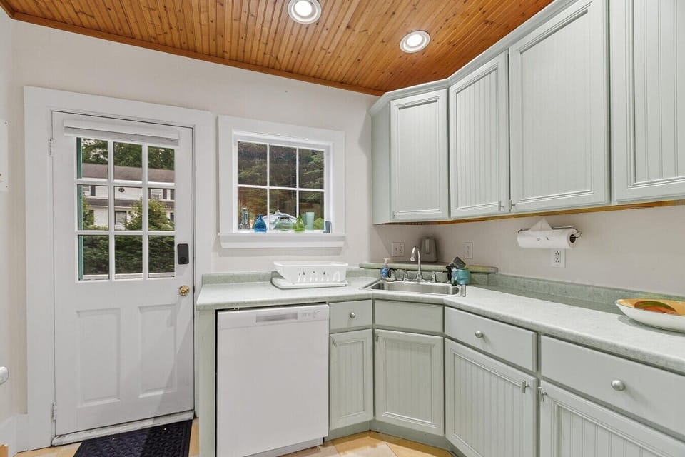 Enter the home through the newly renovated kitchen - stocked with basic amenities for guest use
