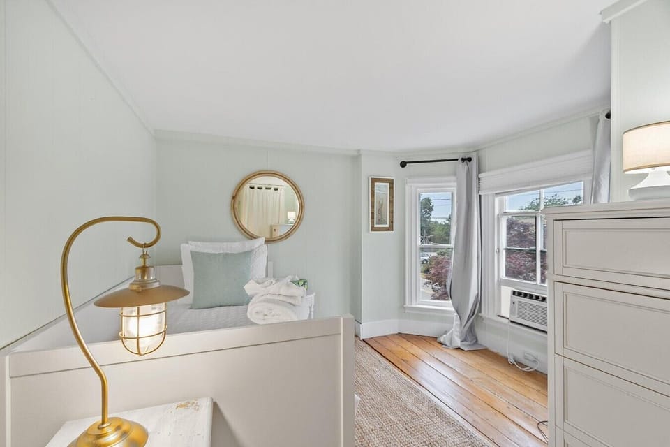 The room is equipped with a window AC unit and has plenty of clothing storage for guests
