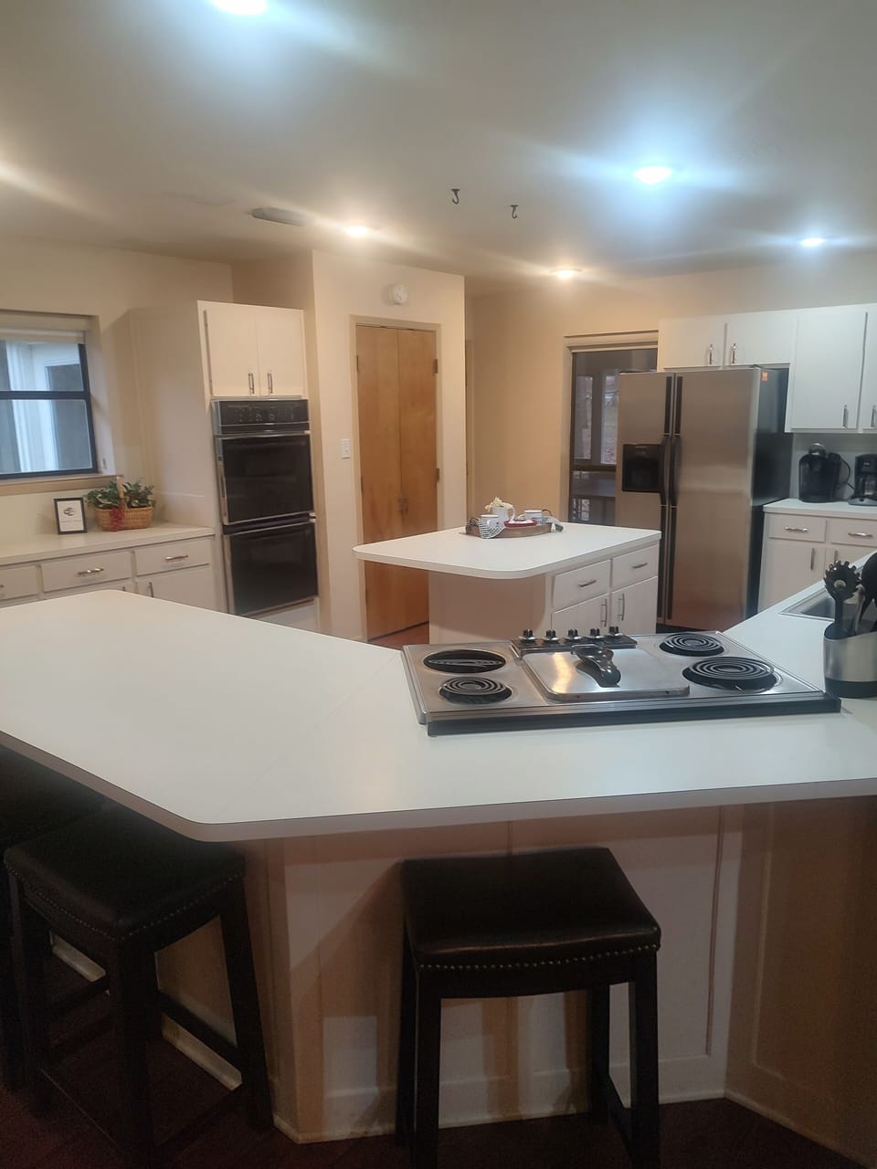 Another view of kitchen with four stools to expand the seating.