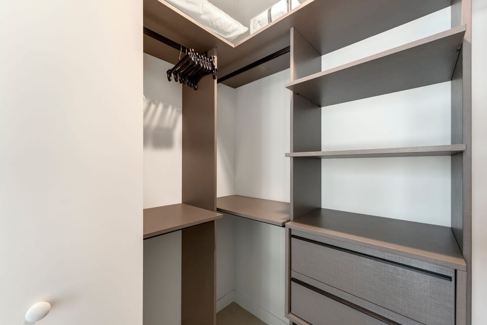 Spacious walk-in closet with shelving and storage