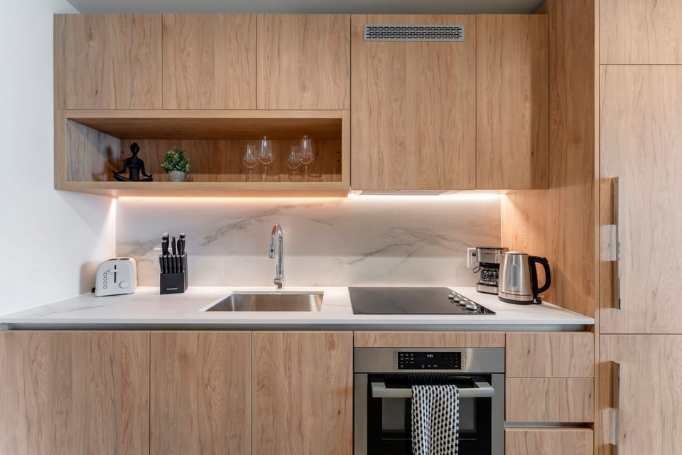 Fully equipped modern kitchen with stainless appliances.