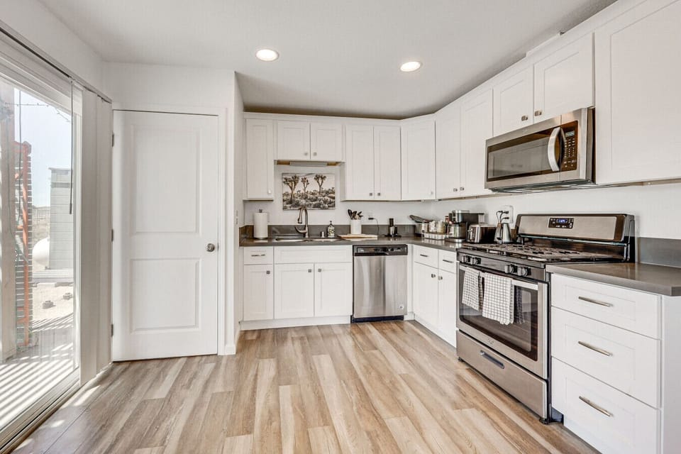 Kitchen | Stainless Steel Appliances | White Cabinetry & Recessed Lighting