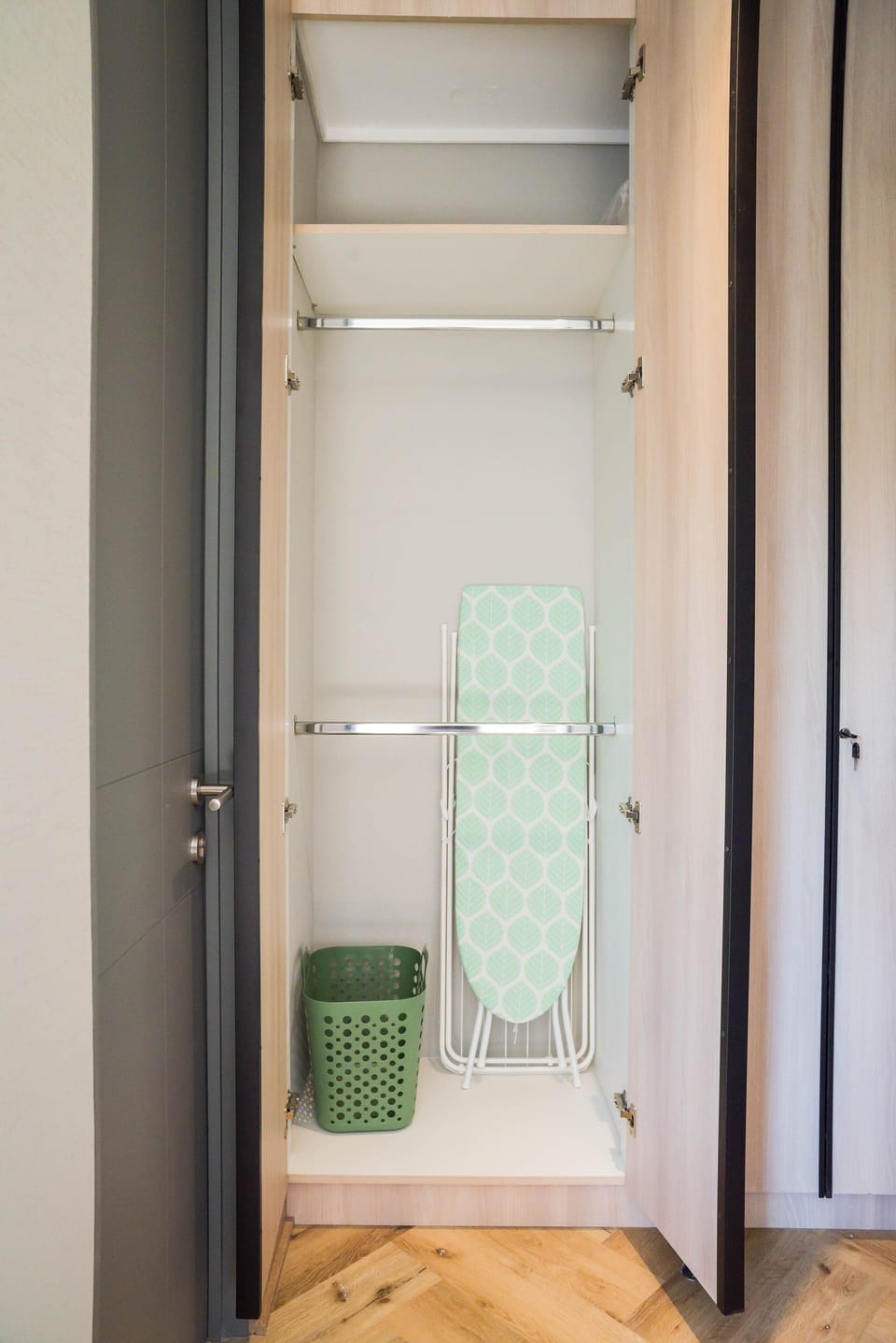 Convenient closet space with ironing board and laundry basket for your stay.