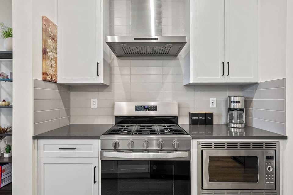 Main floor`s full kitchen with a drip coffee maker, ground coffee, tea, sugar, basic condiments (ketchup, mustard, relish), and an air fryer.