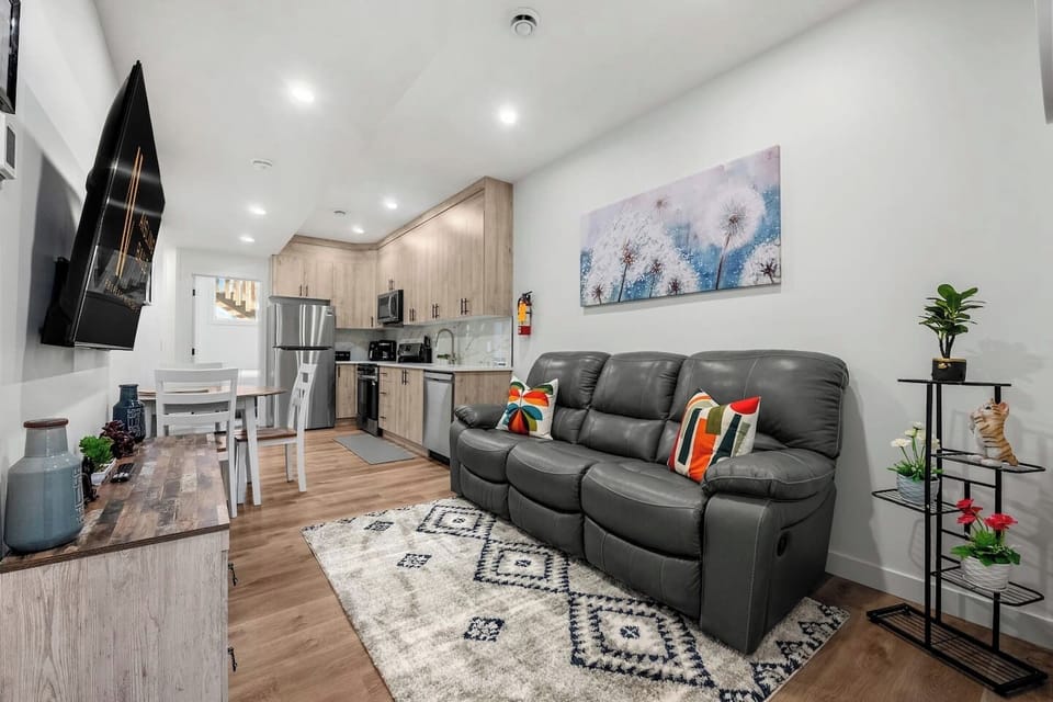 Lower-level living area with a smart TV and a reclining sofa.
