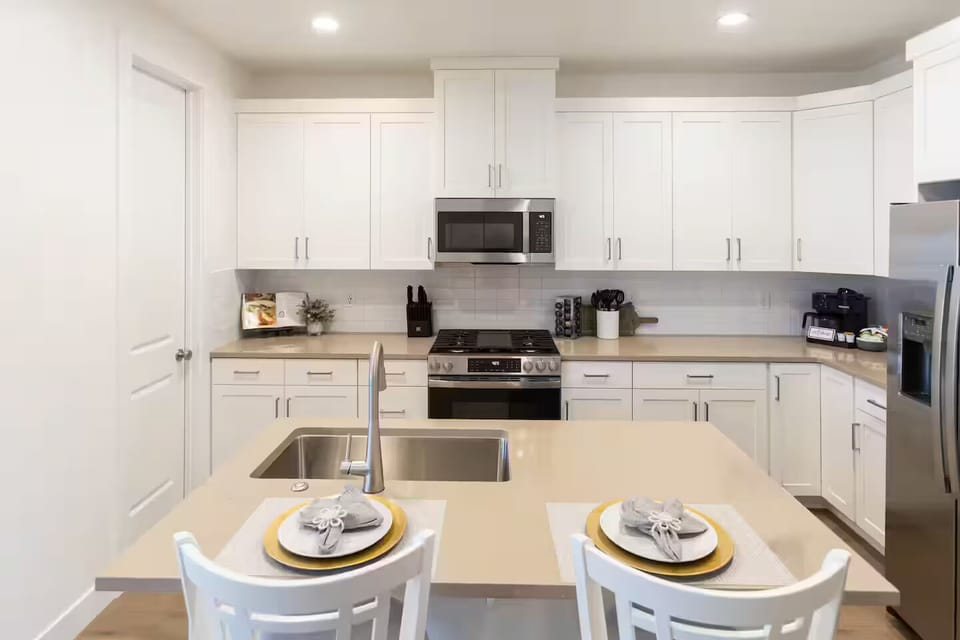 Fully Stocked Gourmet Kitchen featuring seating at the bar
