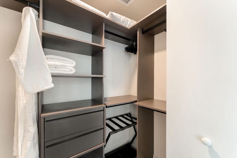 Spacious walk-in closet with shelving and storage