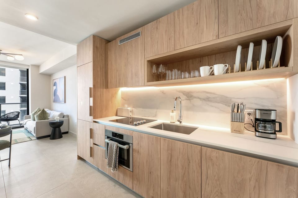 Sleek kitchen with warm wood cabinetry.