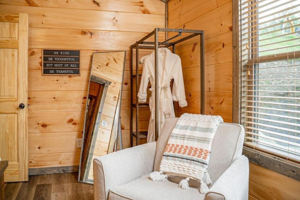 Breezy Retreat: Unwind in style with plush seating and warm wooden accents, perfect for relaxation!