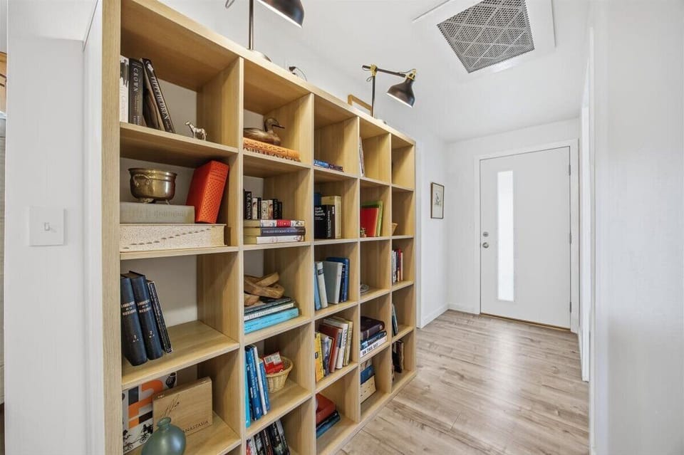Hallway bookshelf with reading and game options