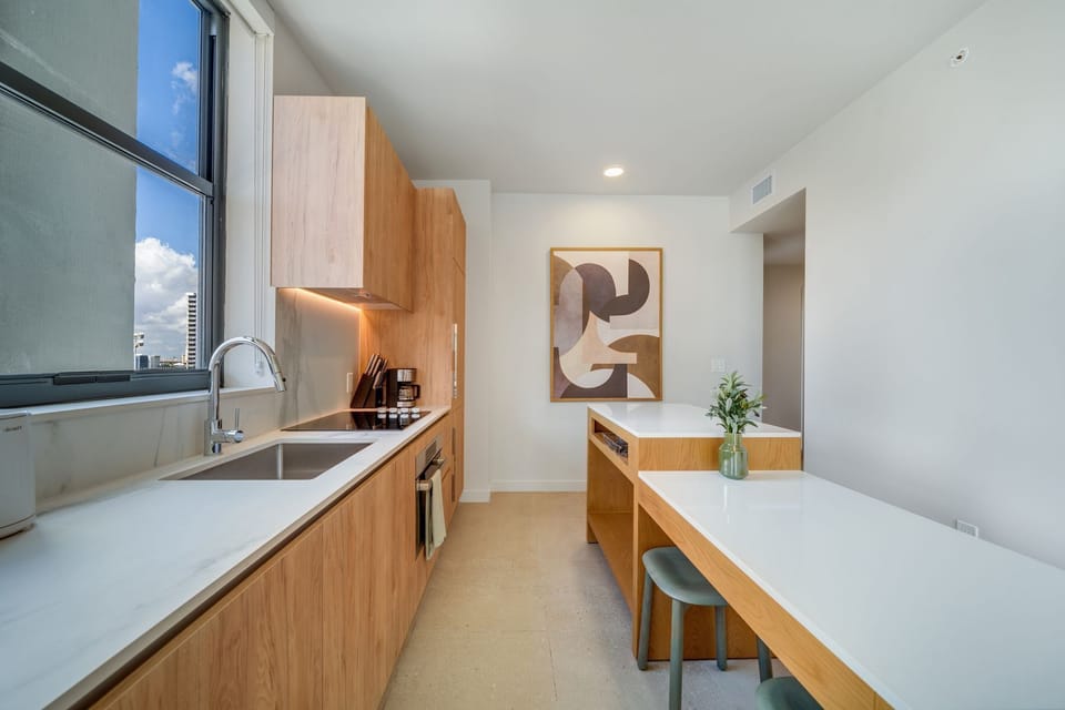 Open kitchen + dining with city backdrop