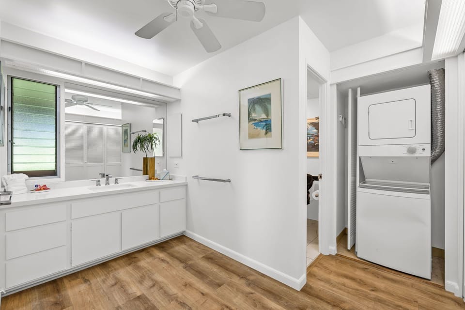 Bright hallway with additional cabinetry and washer‑dryer access enhances functionality while maintaining a polished interior flow